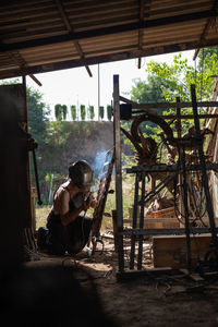 Rear view of man sitting on chair