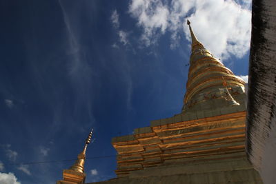 Low angle view of pagoda against cloudy sky