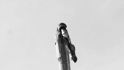 Low angle view of statue against sky