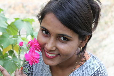 Portrait of smiling young woman outdoors