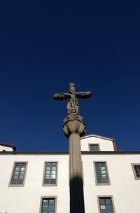 Low angle view of statue against clear blue sky