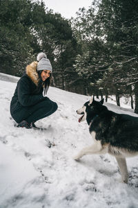 Dog on snow covered landscape during winter