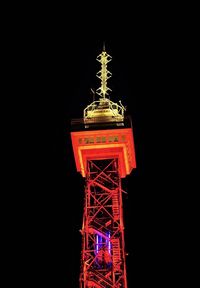 Low angle view of illuminated tower at night