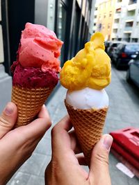 Cropped hand holding ice cream cone