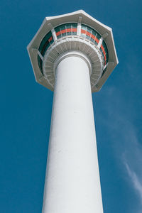 Low angle view of tower against blue sky