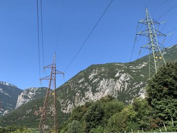 Low angle view of power lines against sky