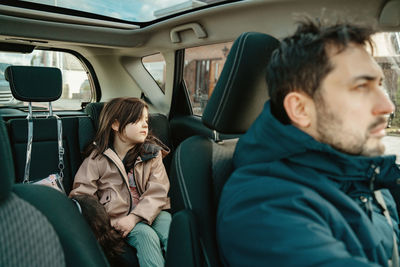 Portrait of smiling friends sitting in car