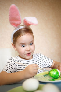 Girl painting eggs