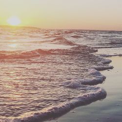 Scenic view of beach against sky during sunset