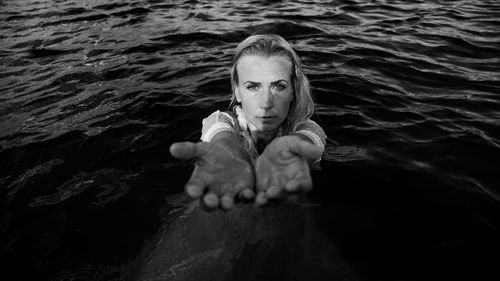 High angle portrait of woman swimming in sea