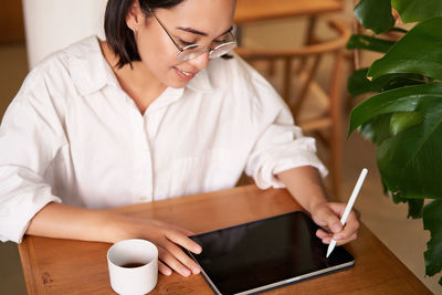 Female friends working at table