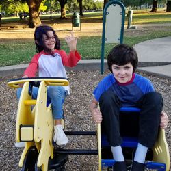 Full length portrait of smiling siblings