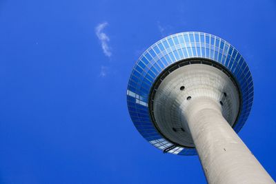 Low angle view of tower against blue sky