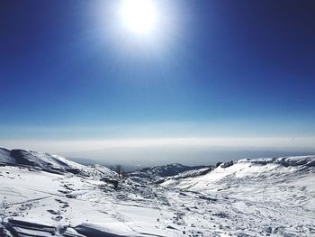 Scenic view of snow covered landscape against sky