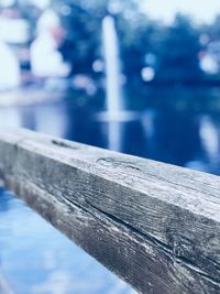 Close-up of wooden railing by pier