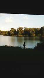 Calm lake with trees in background