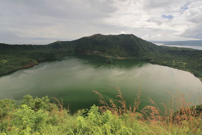 Scenic view of lake and mountains against sky