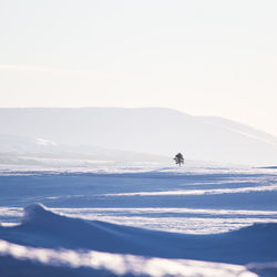 Scenic view of snow covered landscape against clear sky