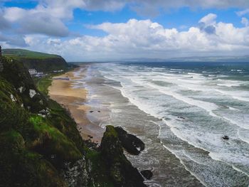 Scenic view of sea coast against sky