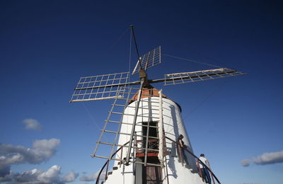 Low angle view of man and woman on traditional windmill steps