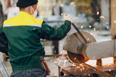 Rear view of man working at construction site