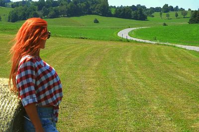 Woman standing on field against sky