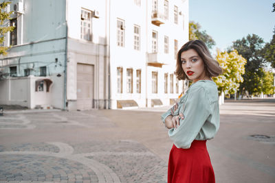 Portrait of young woman standing outdoors