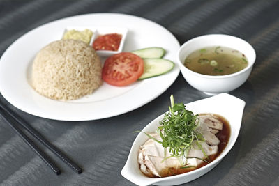 Close-up of hainanese chicken rice served on table