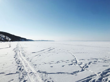 Scenic view of snowcapped mountains against clear blue sky