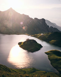 Scenic view of lake and mountains against sky