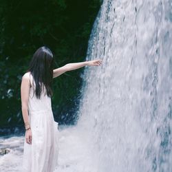 Rear view of woman in water