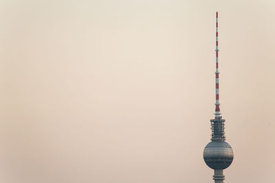 High section of fernsehturm television tower against clear sky during sunset