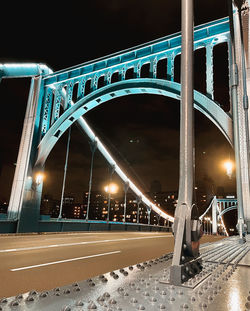 Illuminated bridge against sky at night