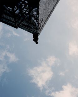 Low angle view of building against cloudy sky