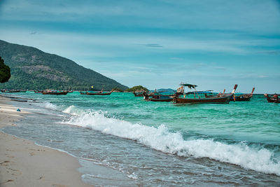 Thai traditional long tail boats resting on the shores of the magical island koh lipe