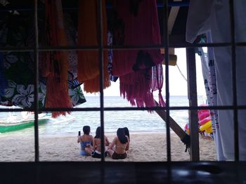 Group of people sitting at the sea