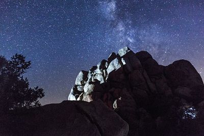 Rock formation against sky at night