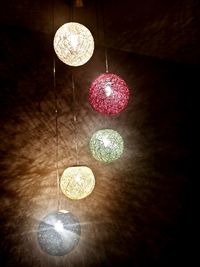 Low angle view of illuminated chandelier hanging from ceiling