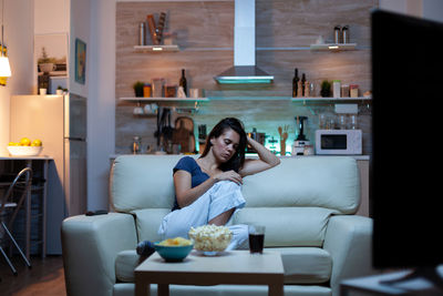 Portrait of young woman sitting at home