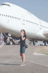 Portrait of woman standing on airplane