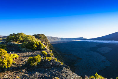 Scenic view of mountains against clear blue sky