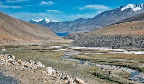 Scenic view of lake and mountains against sky