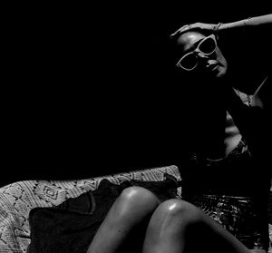 Midsection of man sitting on sofa at home