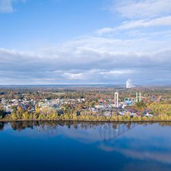 Scenic view of lake and buildings against sky