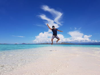 Full length of man at beach against sky