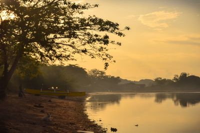 Scenic view of lake against sky during sunset