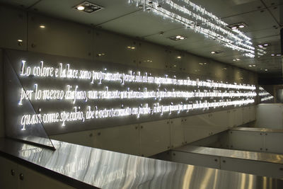 Low angle view of illuminated lights on ceiling