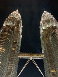 Low angle view of illuminated buildings against sky at night