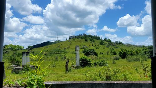 Scenic view of landscape against cloudy sky