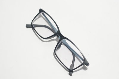 High angle view of eyeglasses against white background